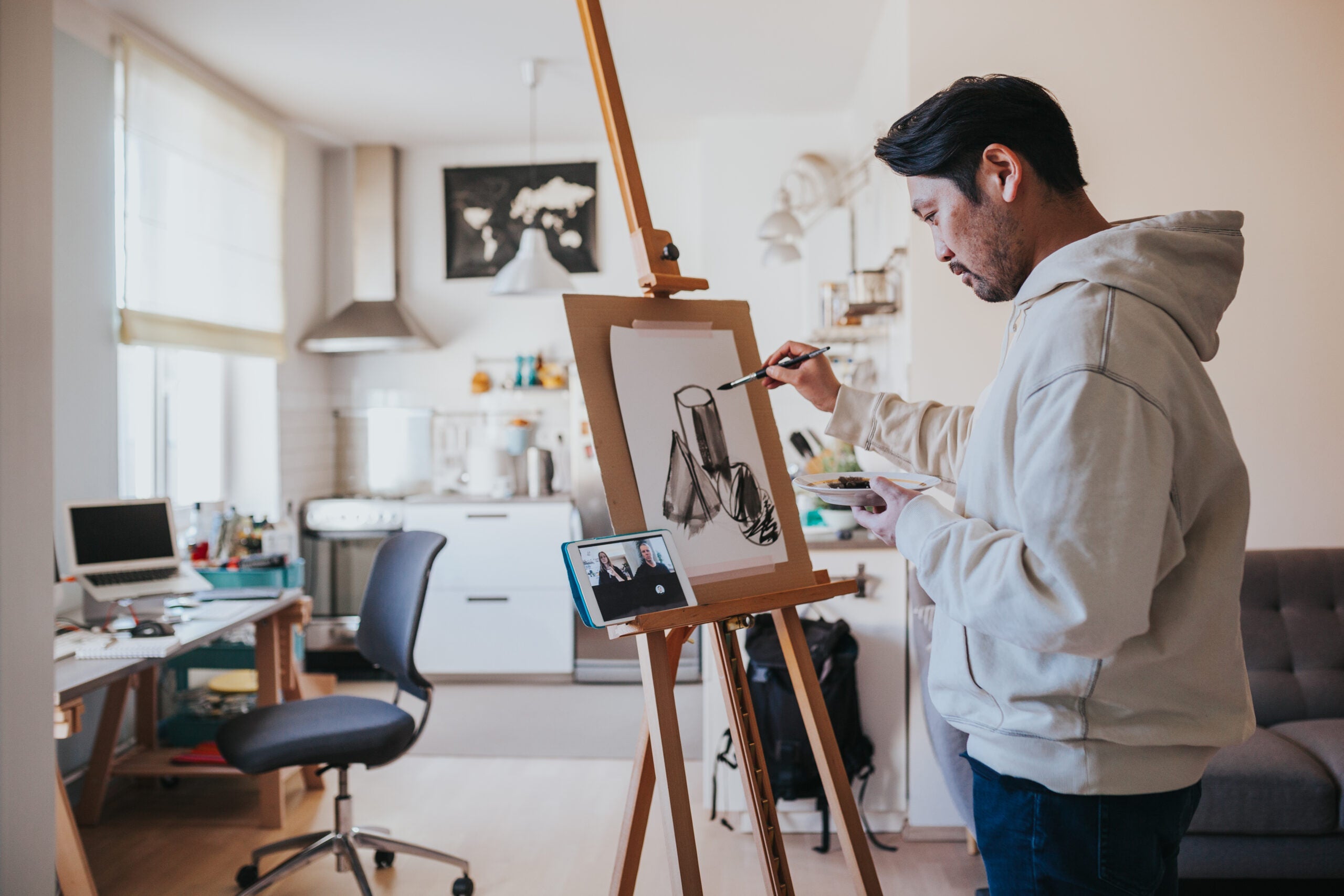 Japanese man paints while having a video call with friends during social distancing times