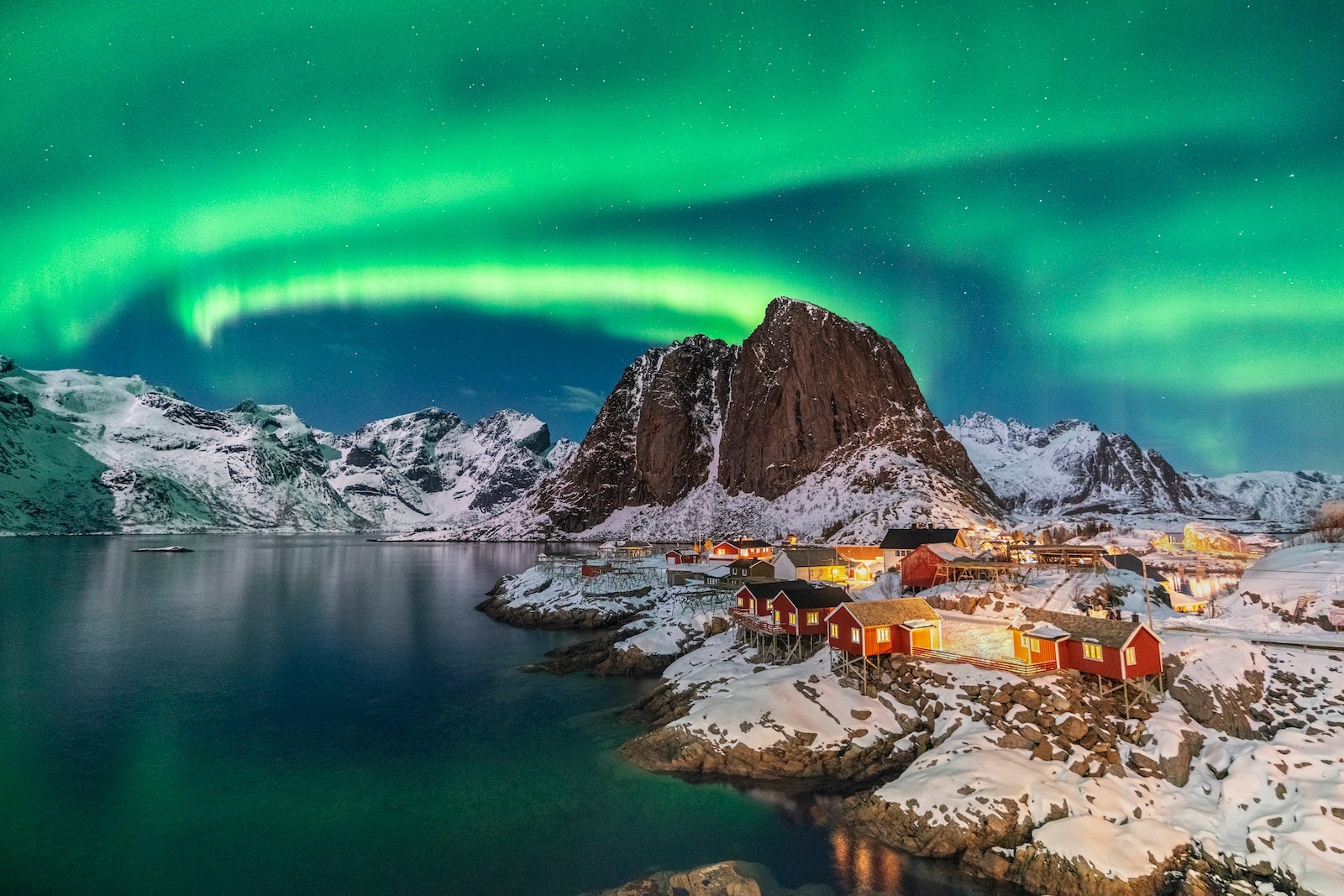 Northern lights above Festhelltinden peak and Hamnoy, Lofoten Islands.