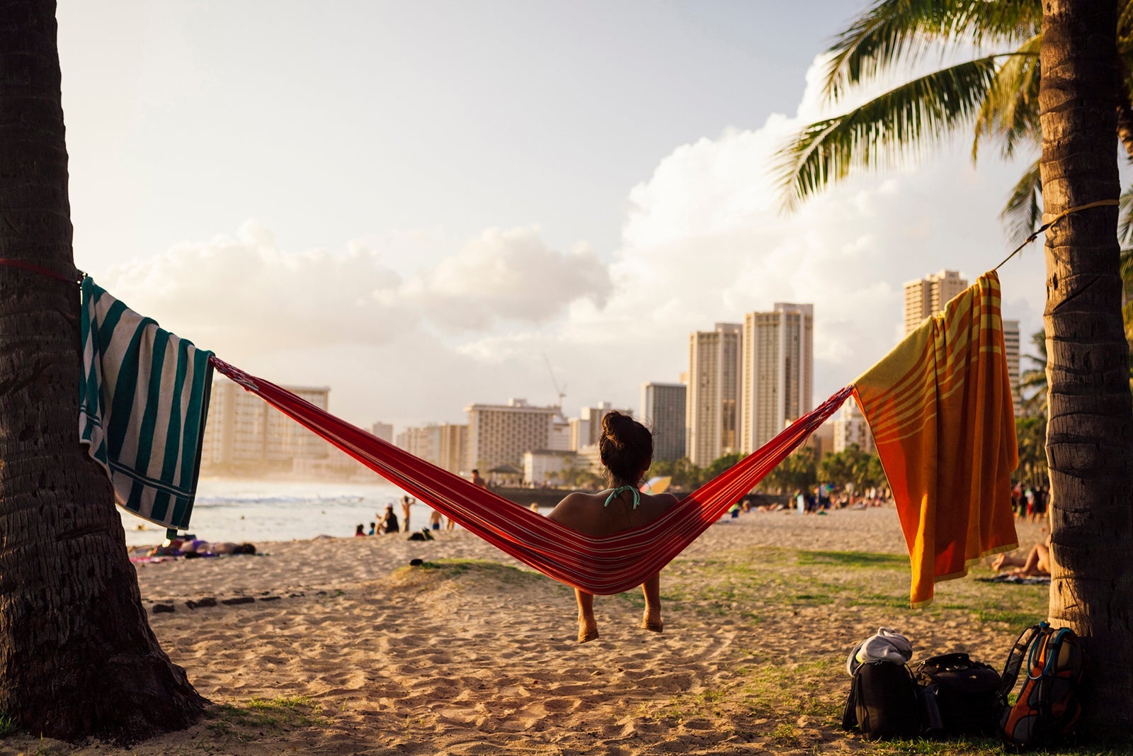 Young woman sitting in hammock at beach, Honolulu, Hawaii Islands, USA