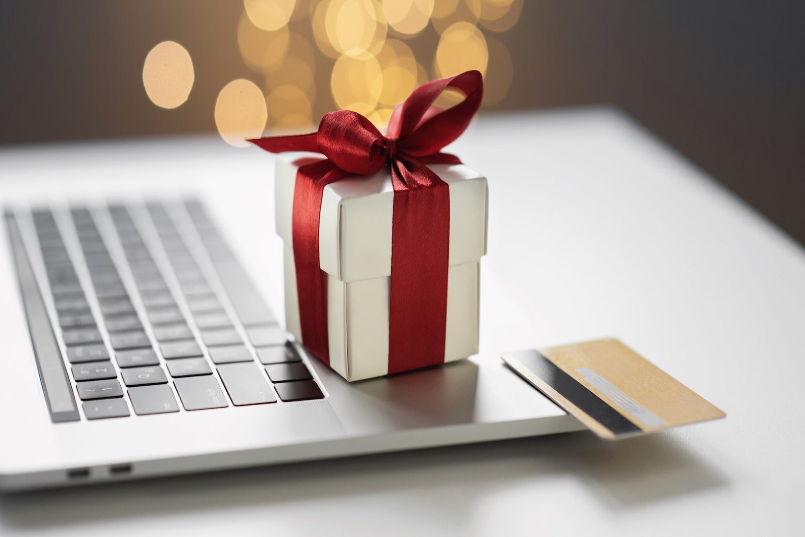 Christmas gift and credit card on laptop. Online shopping during holidays