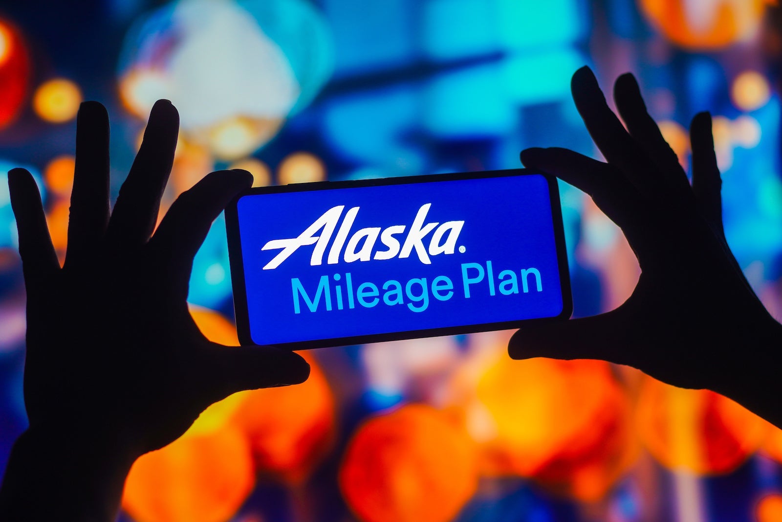 In this photo illustration, the Mileage Plan Alaska Airlines