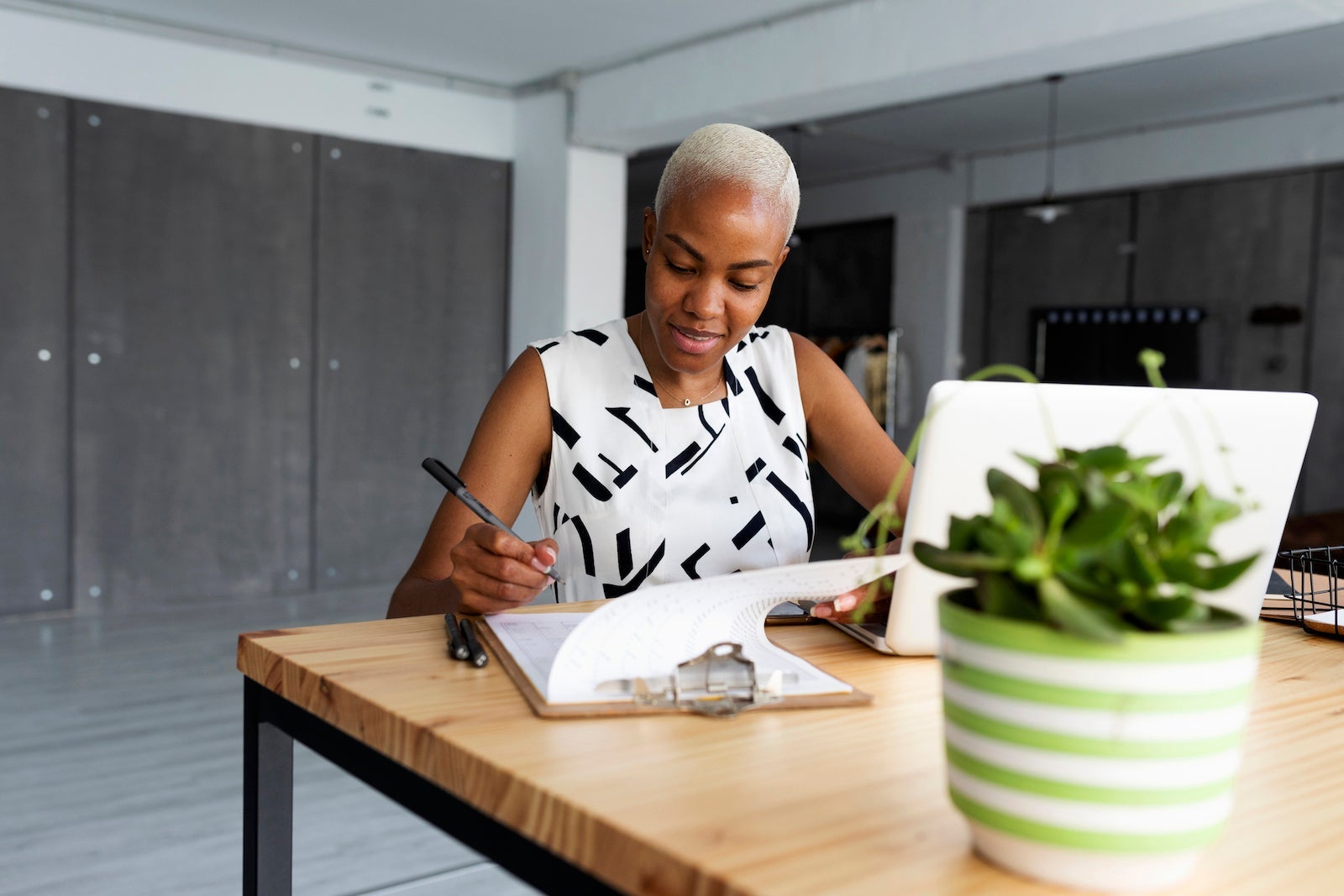 Businesswoman working in modern office, using laptop
