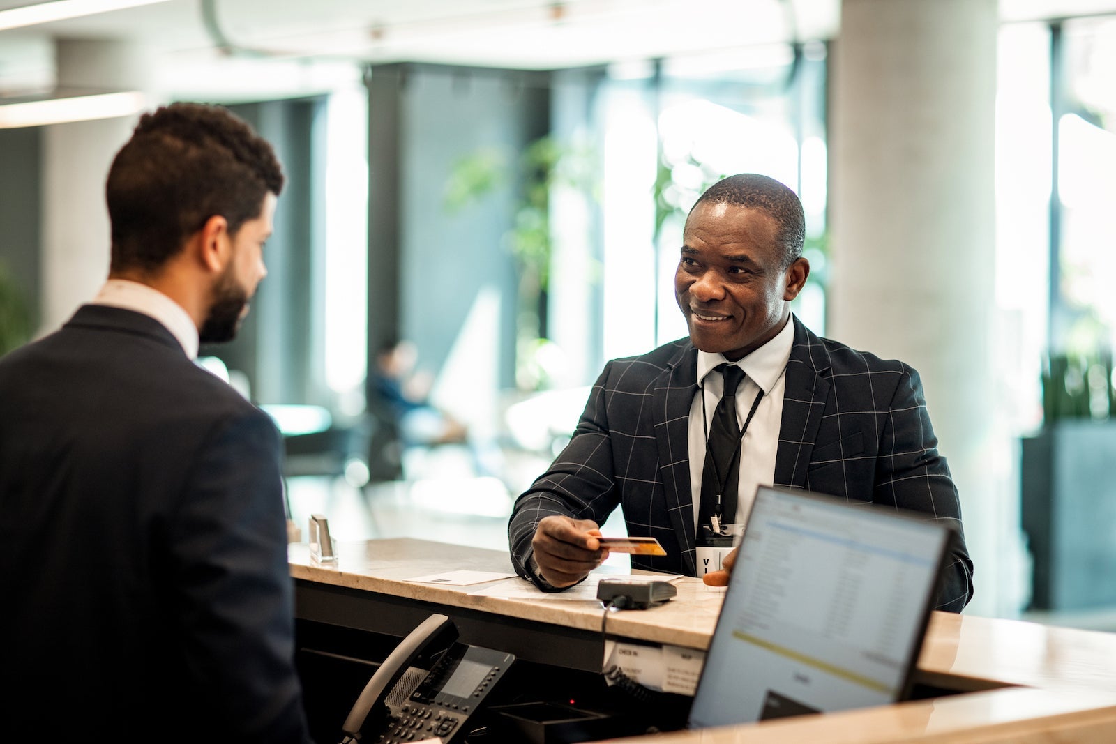 Businessman paying for a hotel room