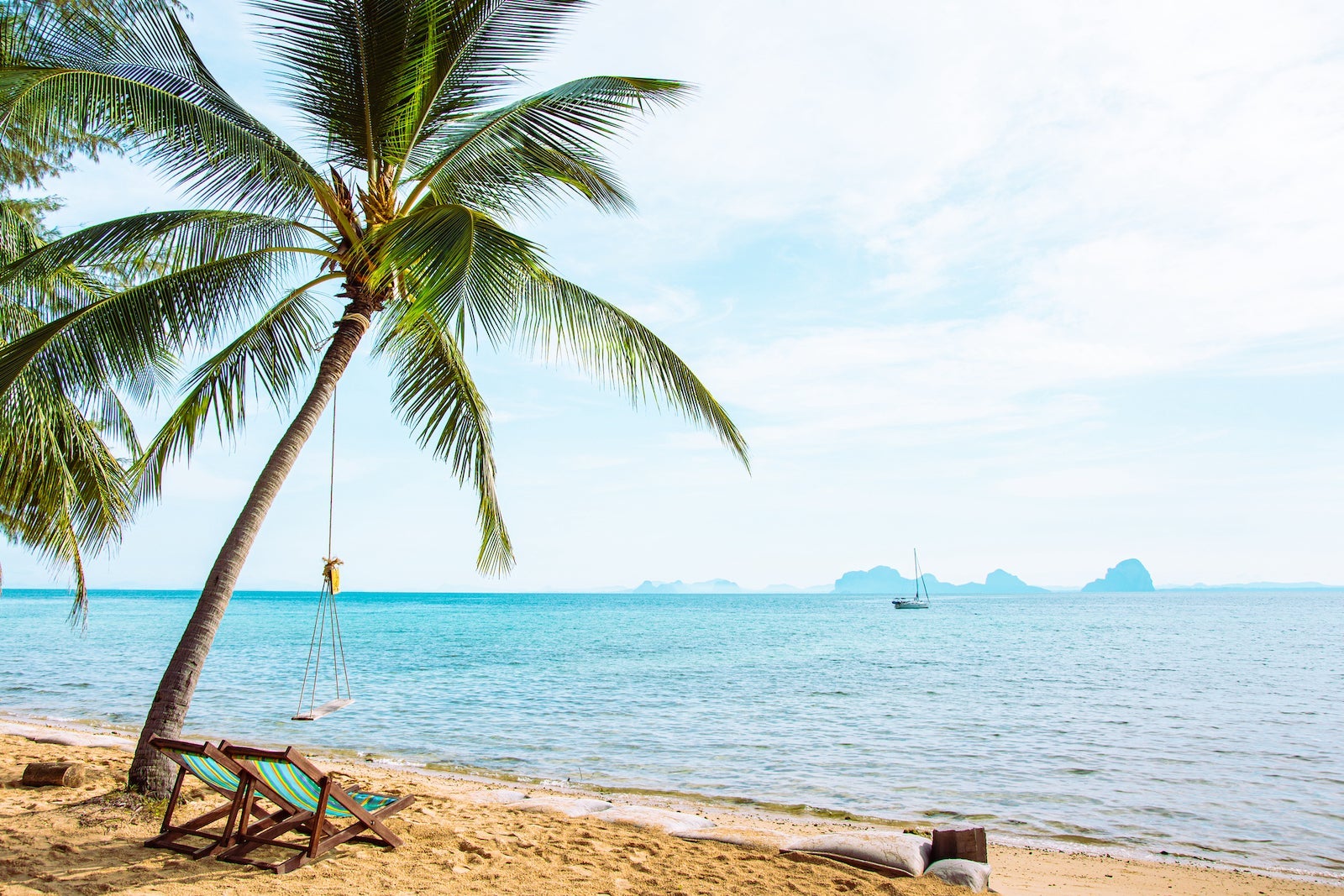 Beautiful beach. Chairs on the sandy beach near the sea.