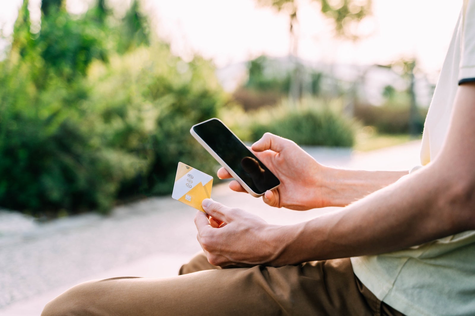 Smartphone and credit card in the hands of a man.