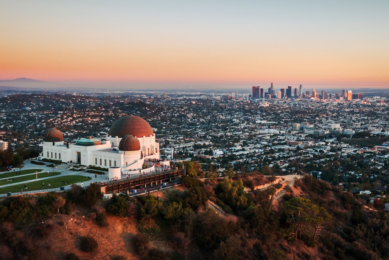 Los Angeles city skyline and Griffith Observatory aerial view at sunset