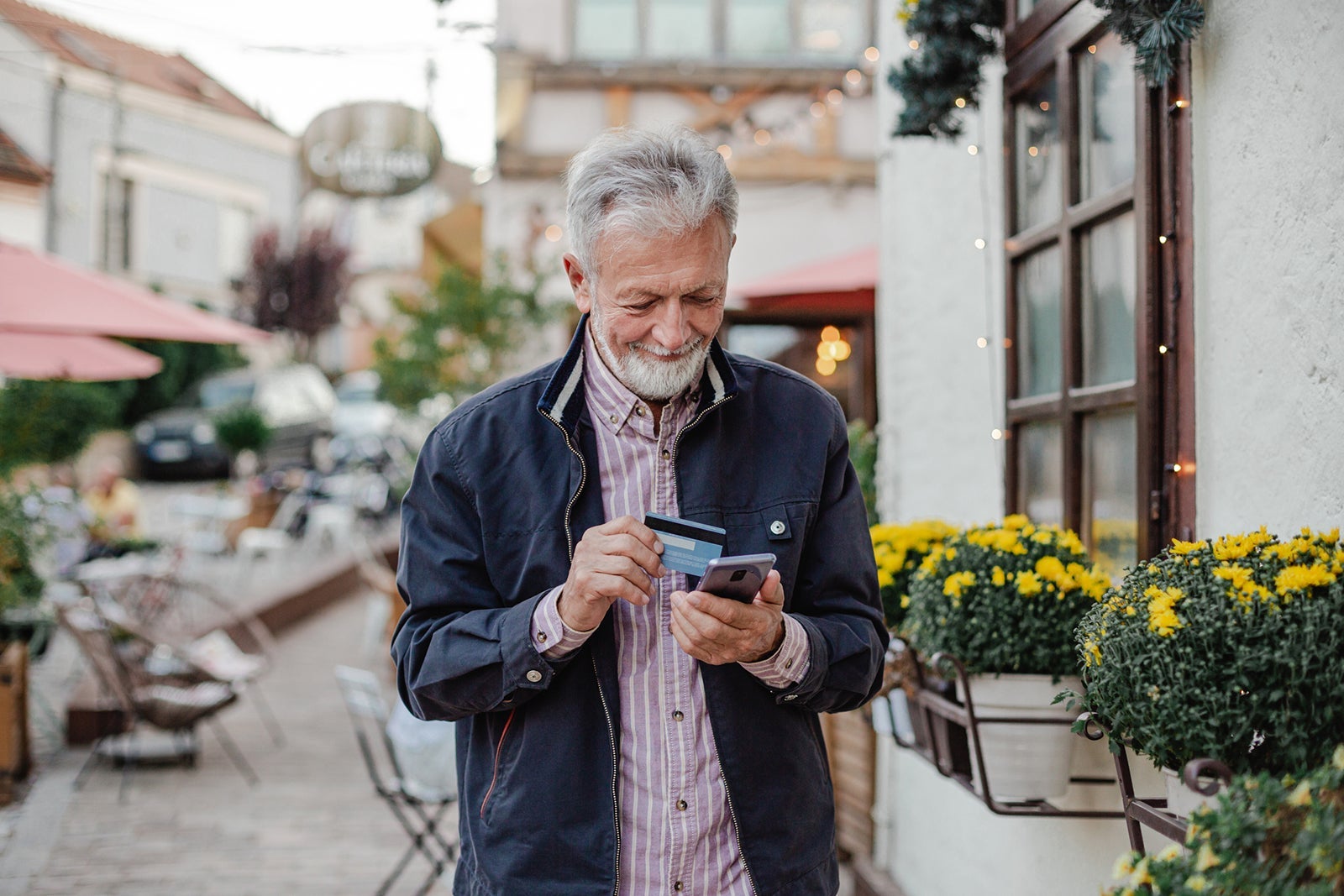 Senior man shopping online on the street
