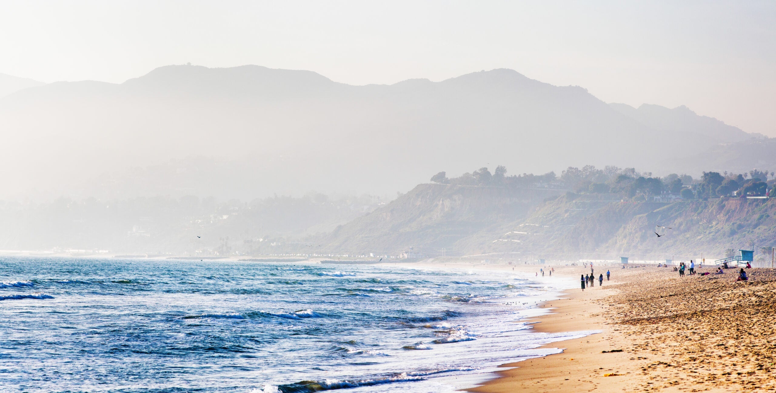 Santa Monica beach on misty evening mountains in background