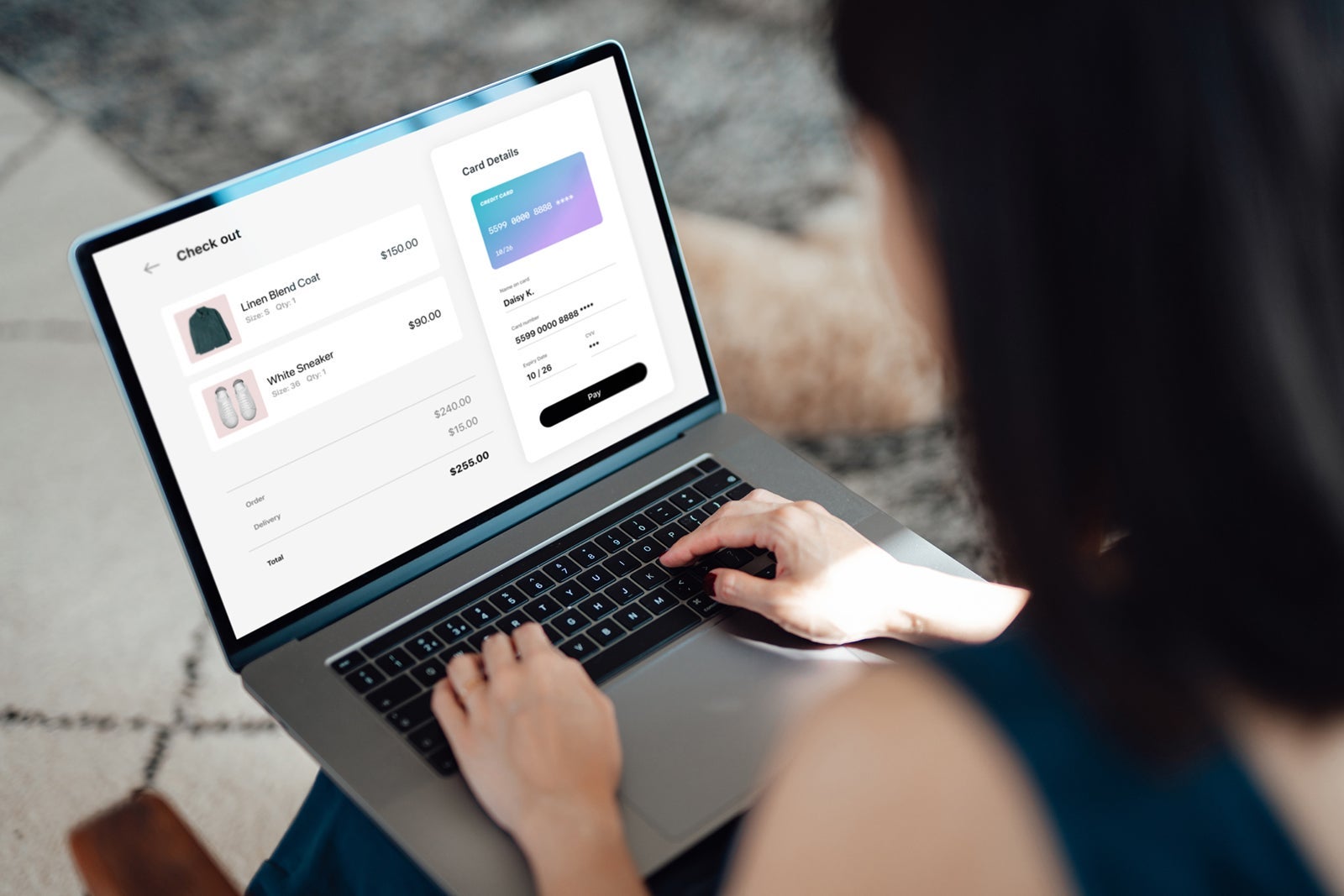 Woman shopping clothes online on laptop and making payment with credit card