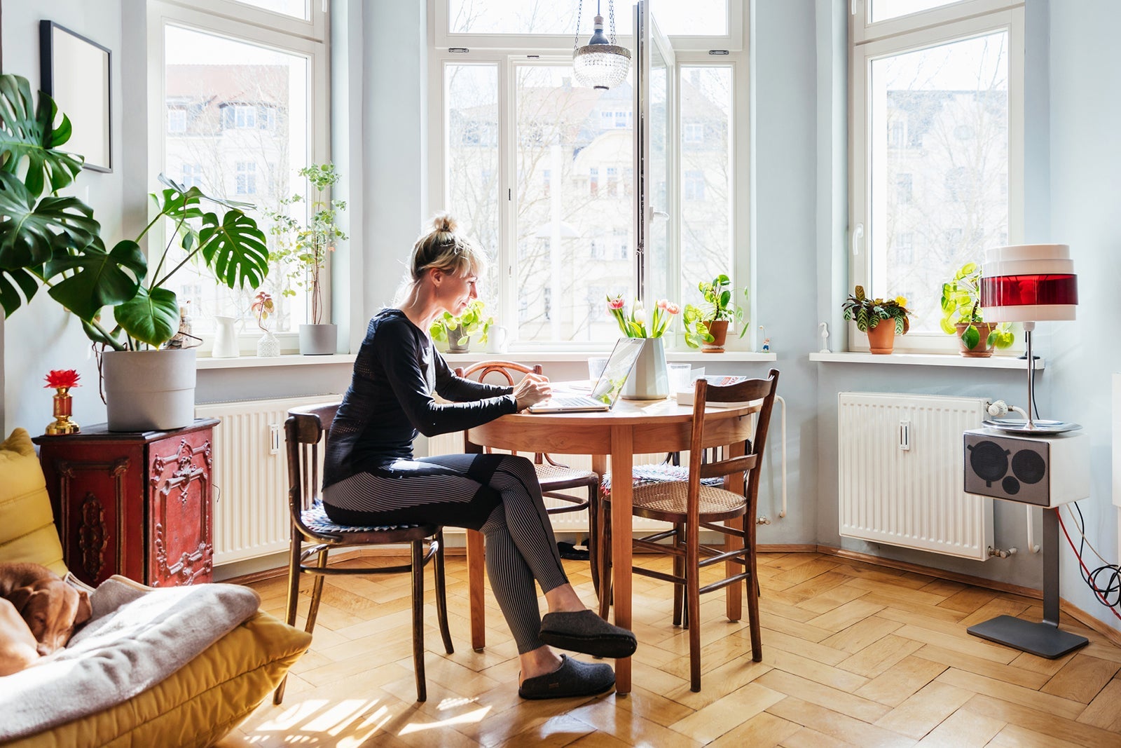 Single Mom Sitting In Living Room Using Laptop