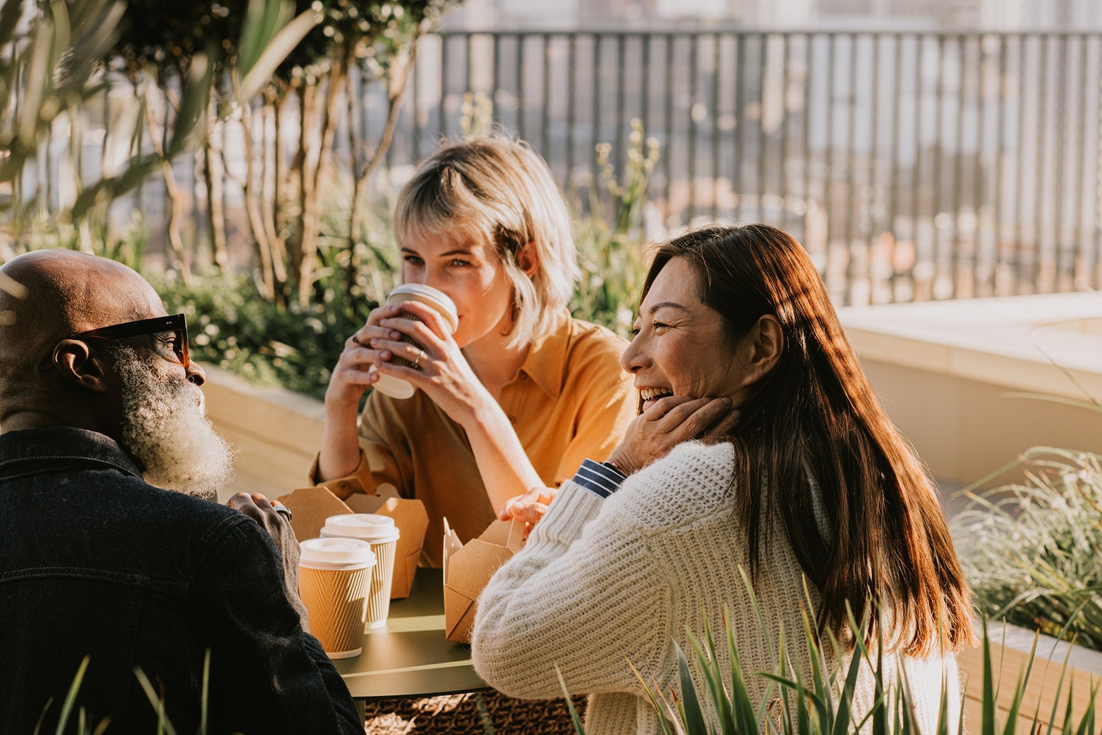 A group of coworkers enjoy an alfresco lunch