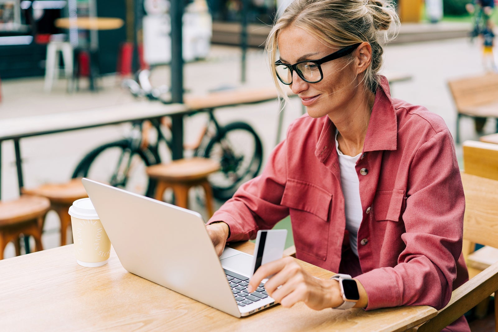 Young attractive caucasian business woman sitting in a cafe working on a laptop.