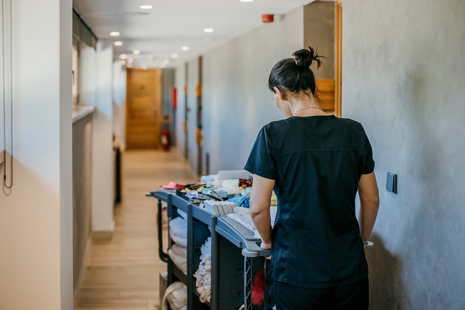 Young hotel maid on work
