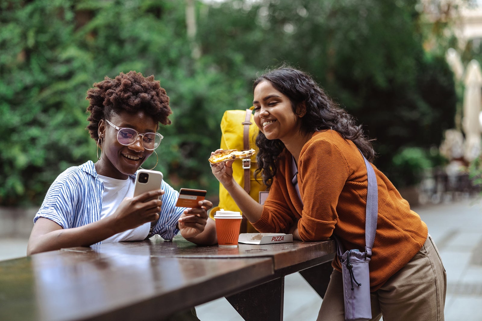 Young woman using e-commerce services on a city break