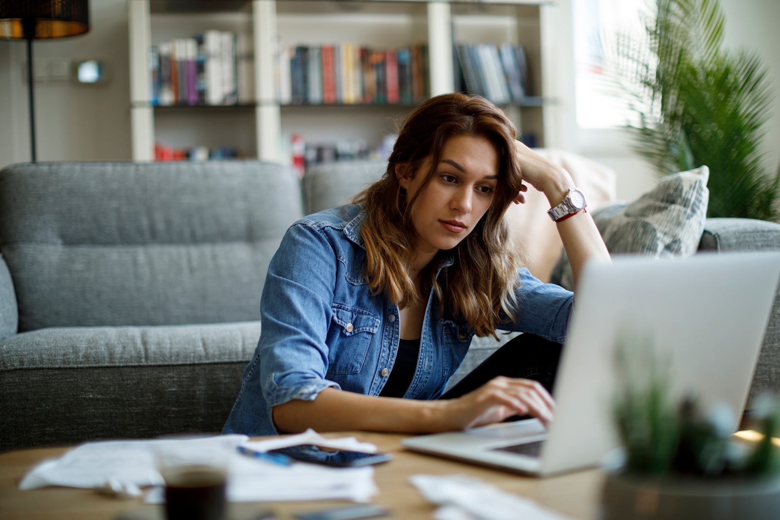 Young woman following online courses on her laptop at home