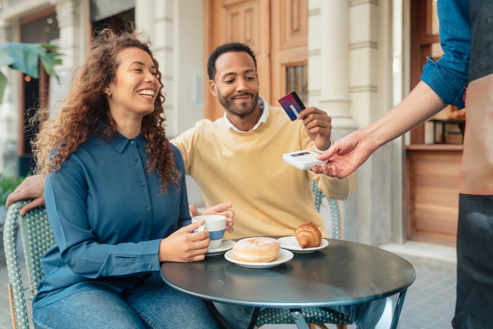 Friends paying at coffee shop
