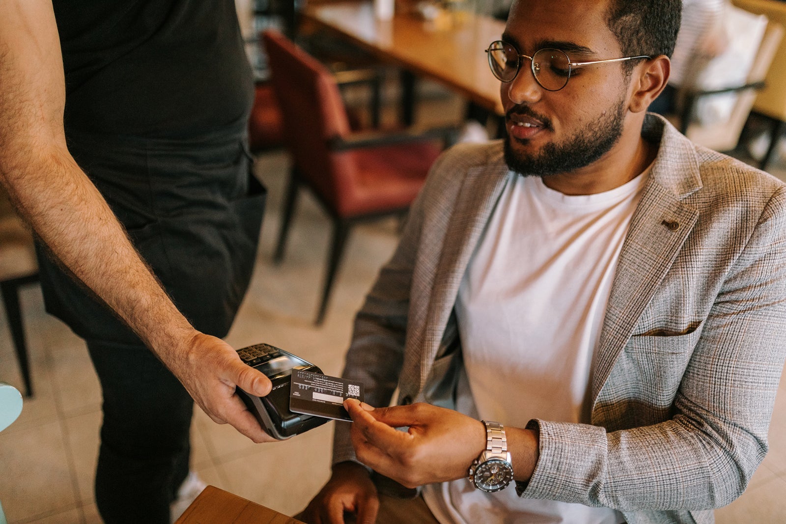 Man pays lunch by card at restaurant