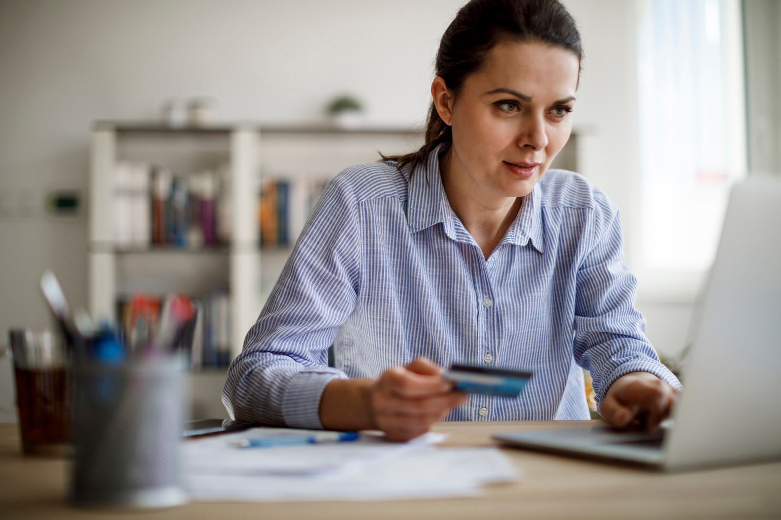 Woman paying bills with a credit card