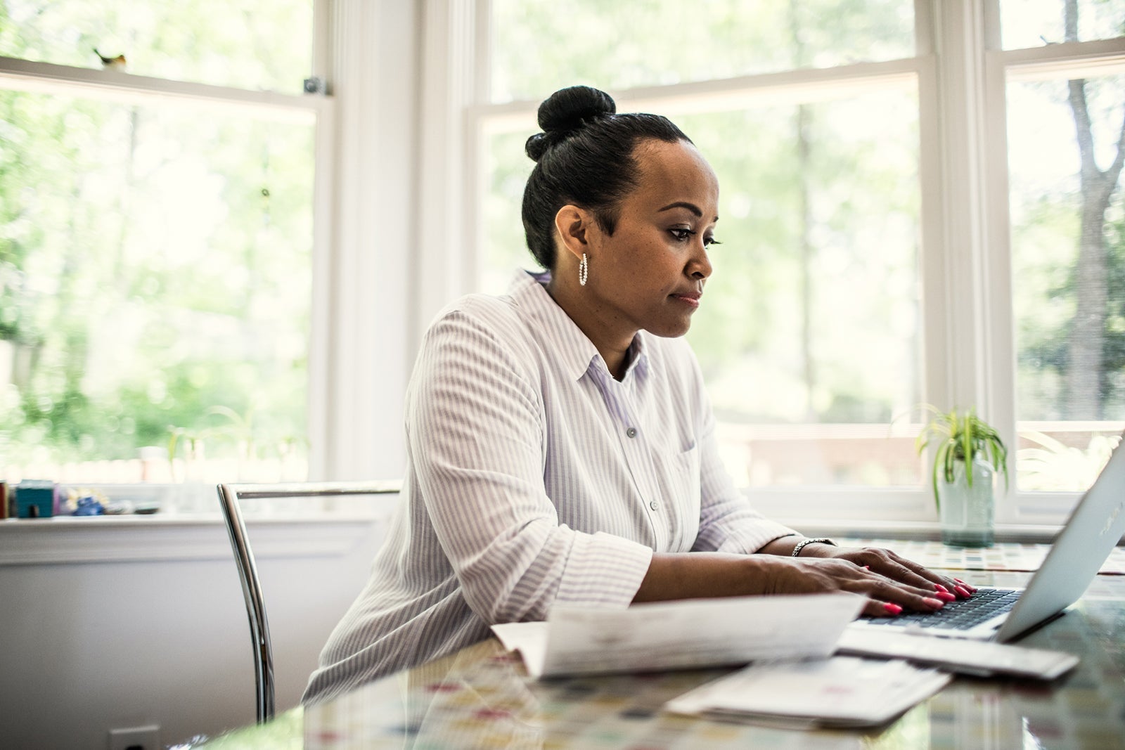 Woman working on laptop in kitchen