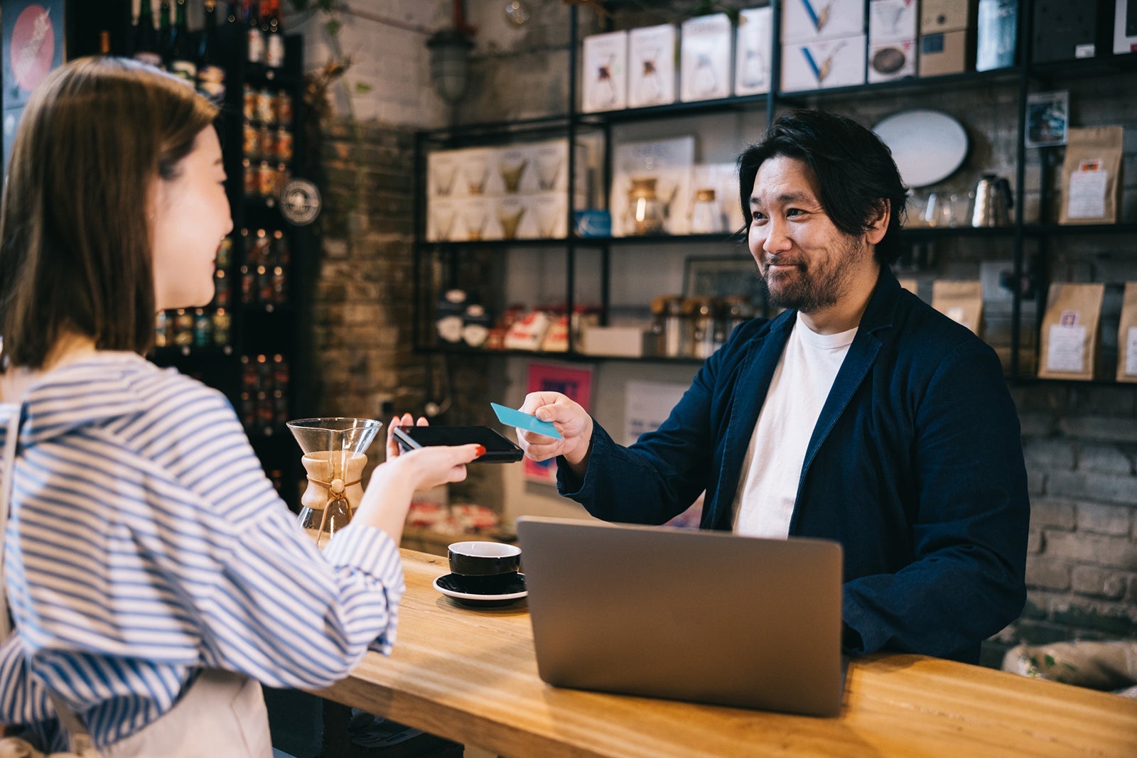 Positive businessman making a contactless payment