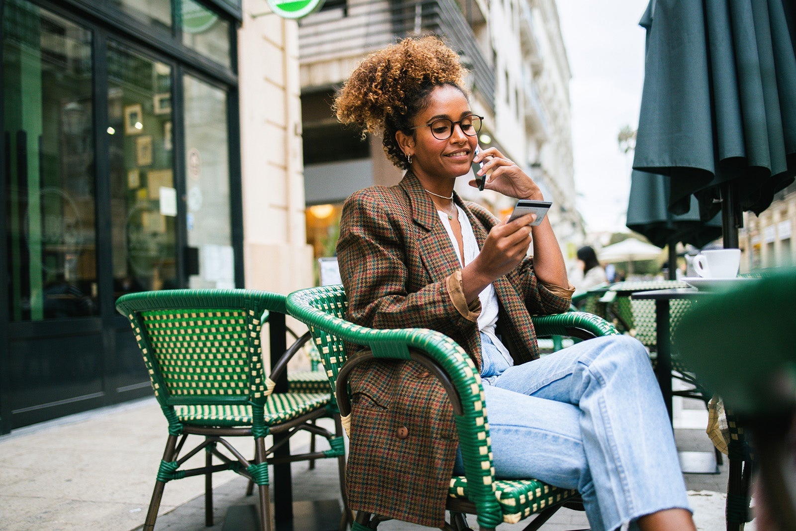 Latin woman enjoying at the cafe and ordering something online