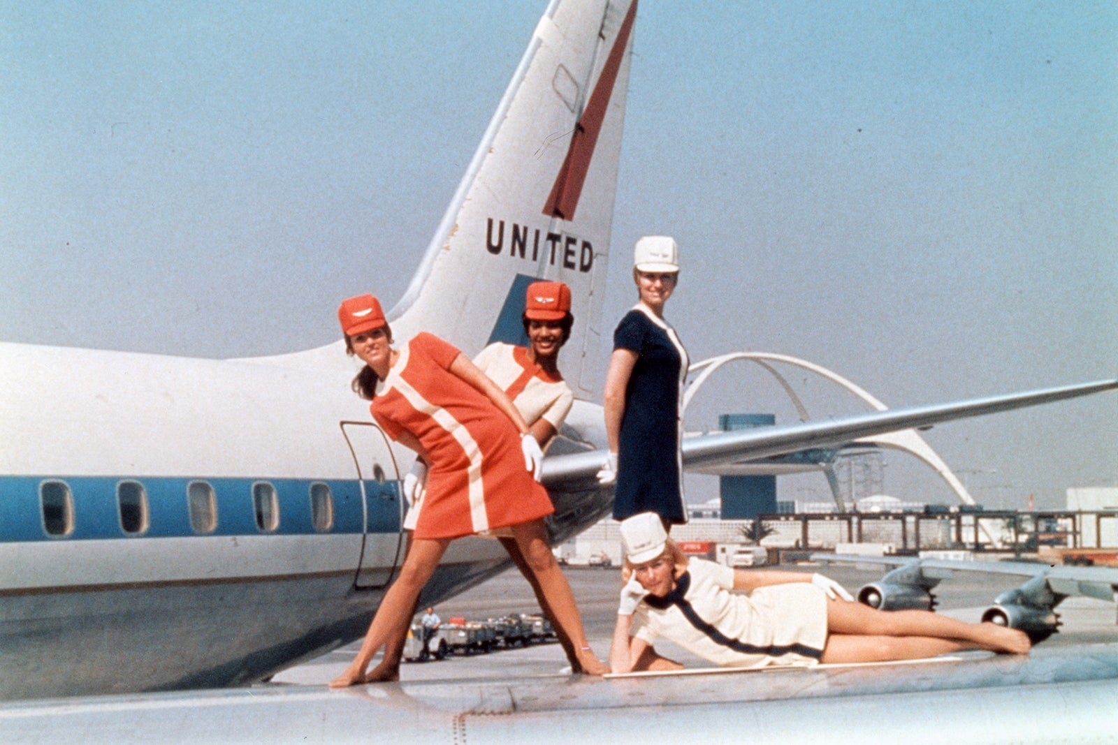 Fly with Me Documentary_Four Stewardesses posed on wing of airplane, circa 1965_United Airlines