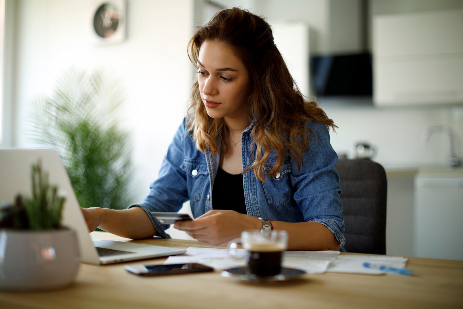 Woman paying bills with a credit card