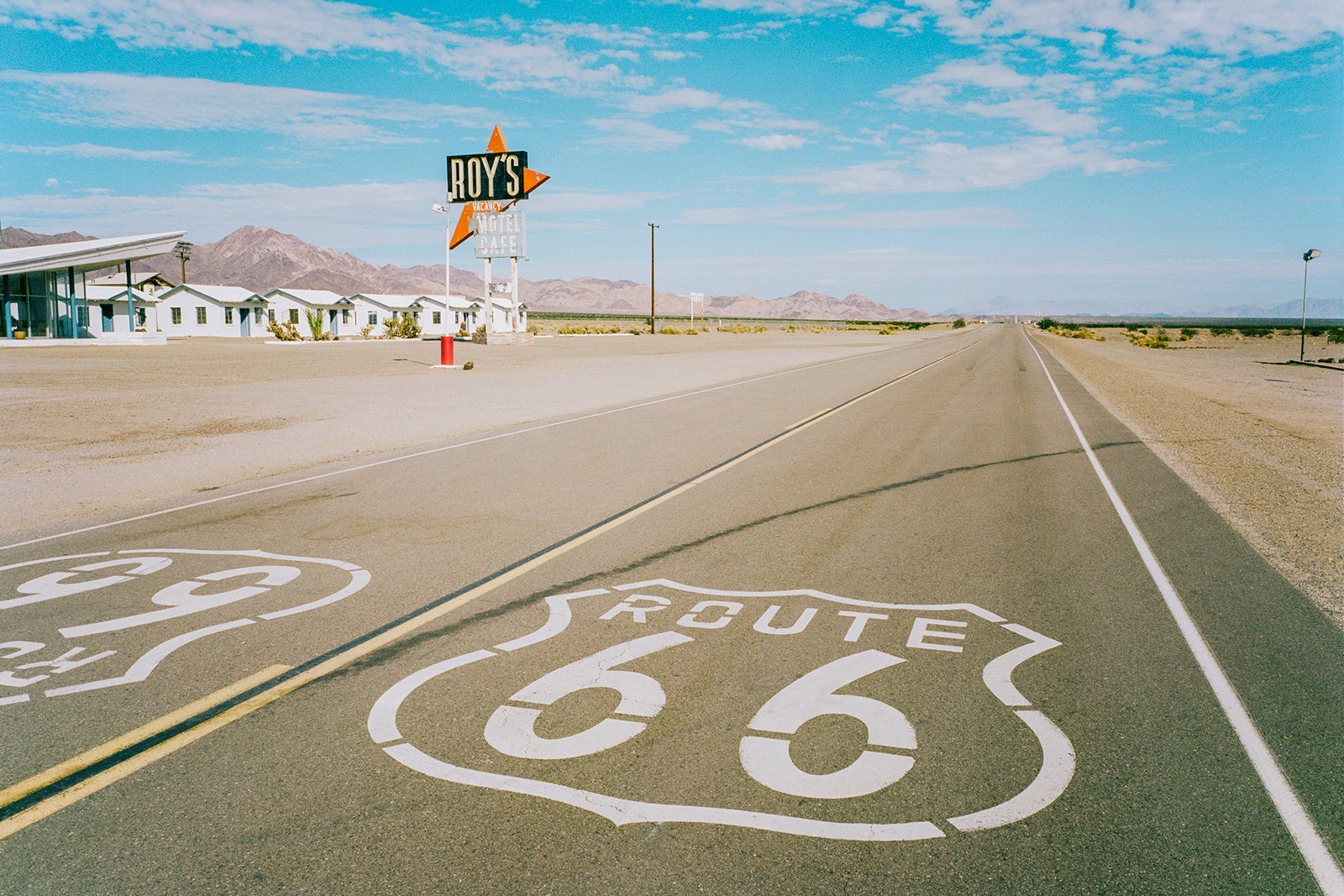 Roue 66 sign in road by a Diner in the desert
