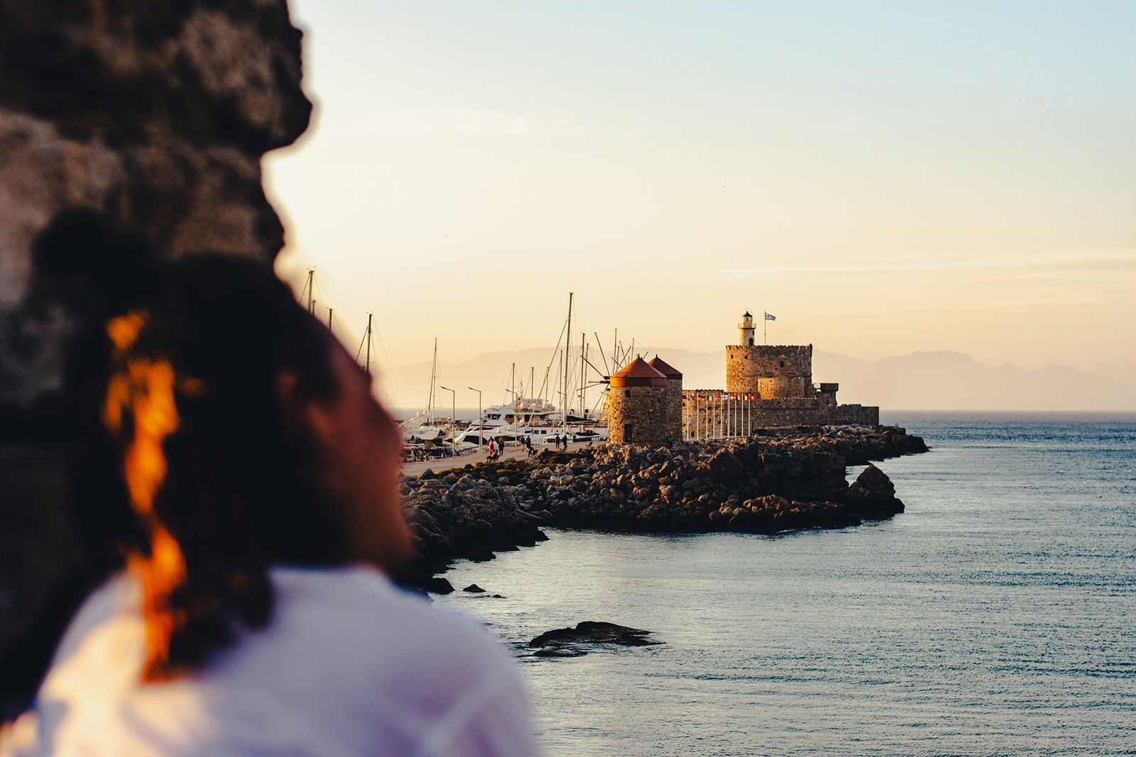 Rear view of woman during sunset in the fortifications of Rhodes