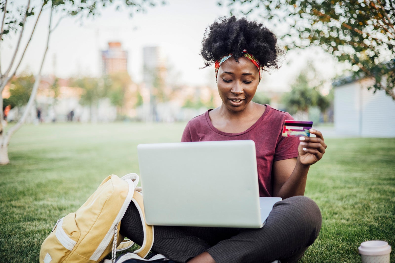 African American young woman shopping online from the park
