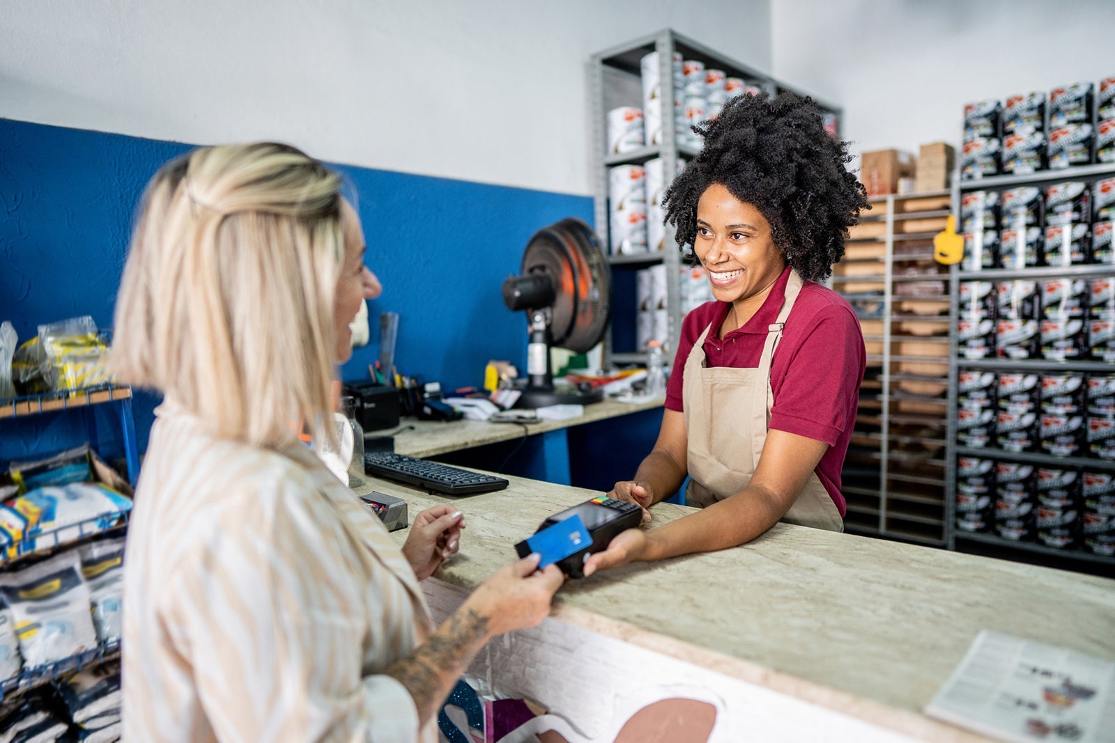 Saleswoman attending a customer at a paint store