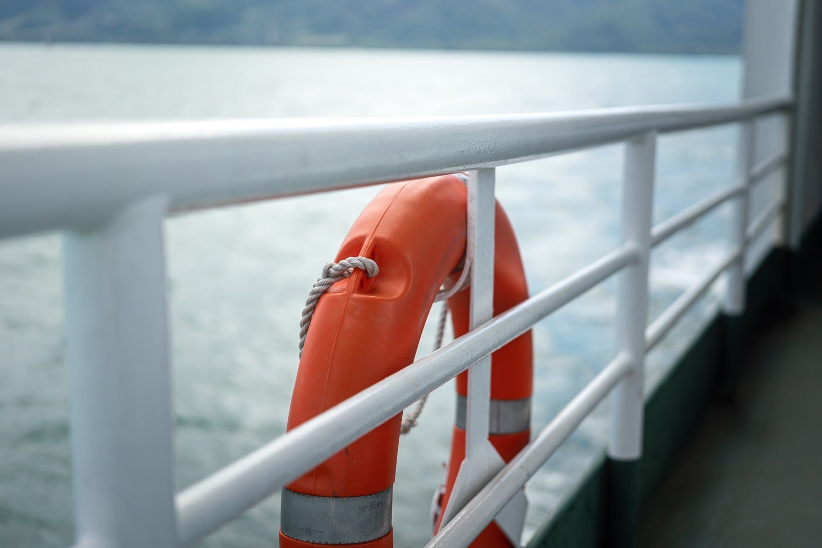 A rescue lifebuoy on ship corridor rail - Emergency equipment.