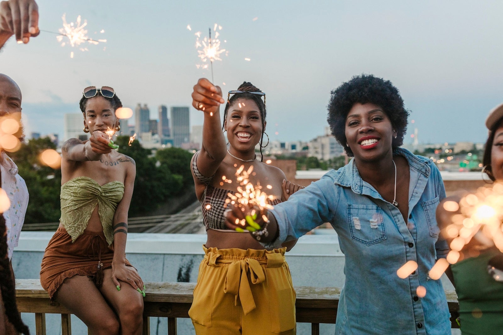 Group Of Friends Having Fun With Sparklers During Rooftop Party