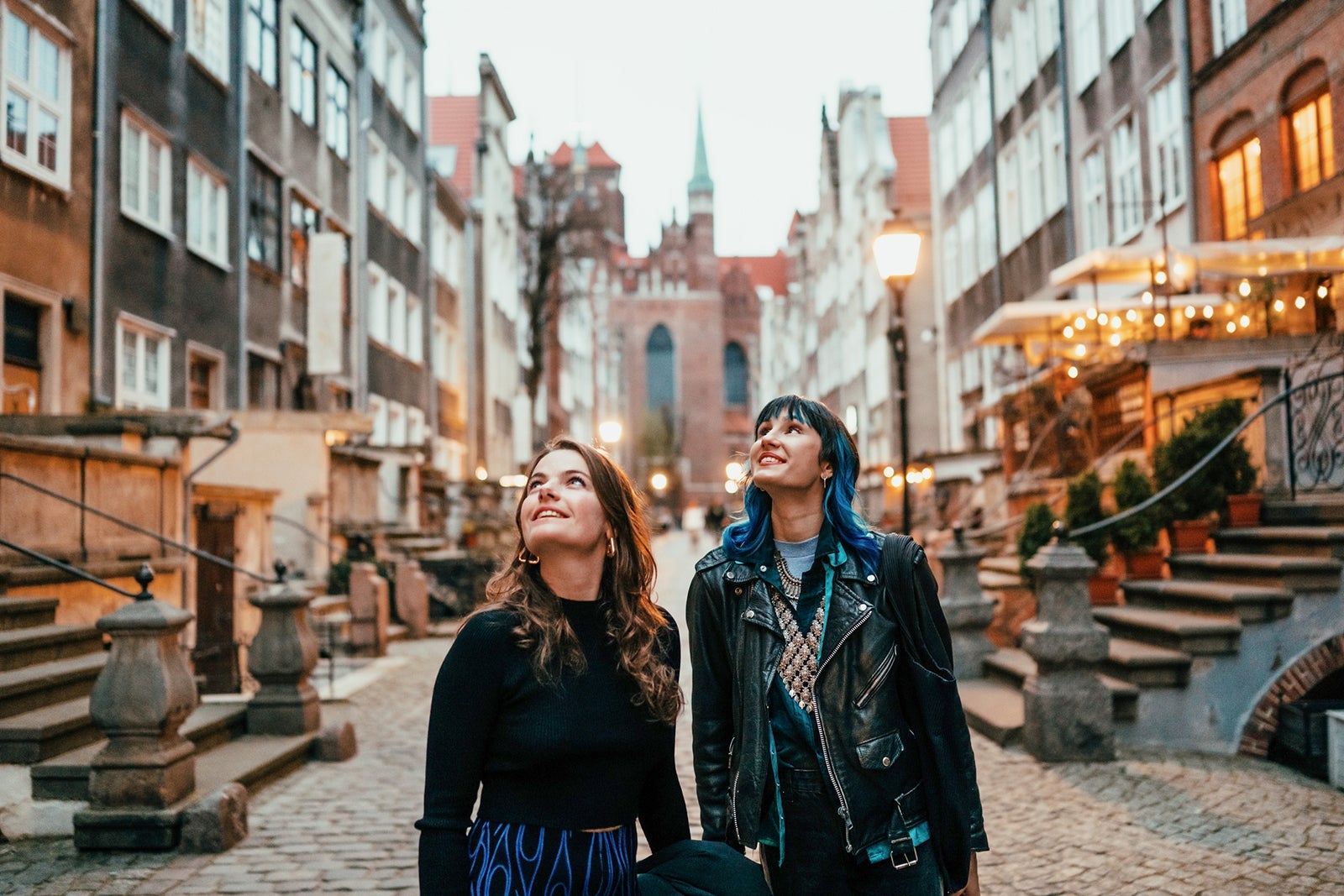Two young women exploring a European old town