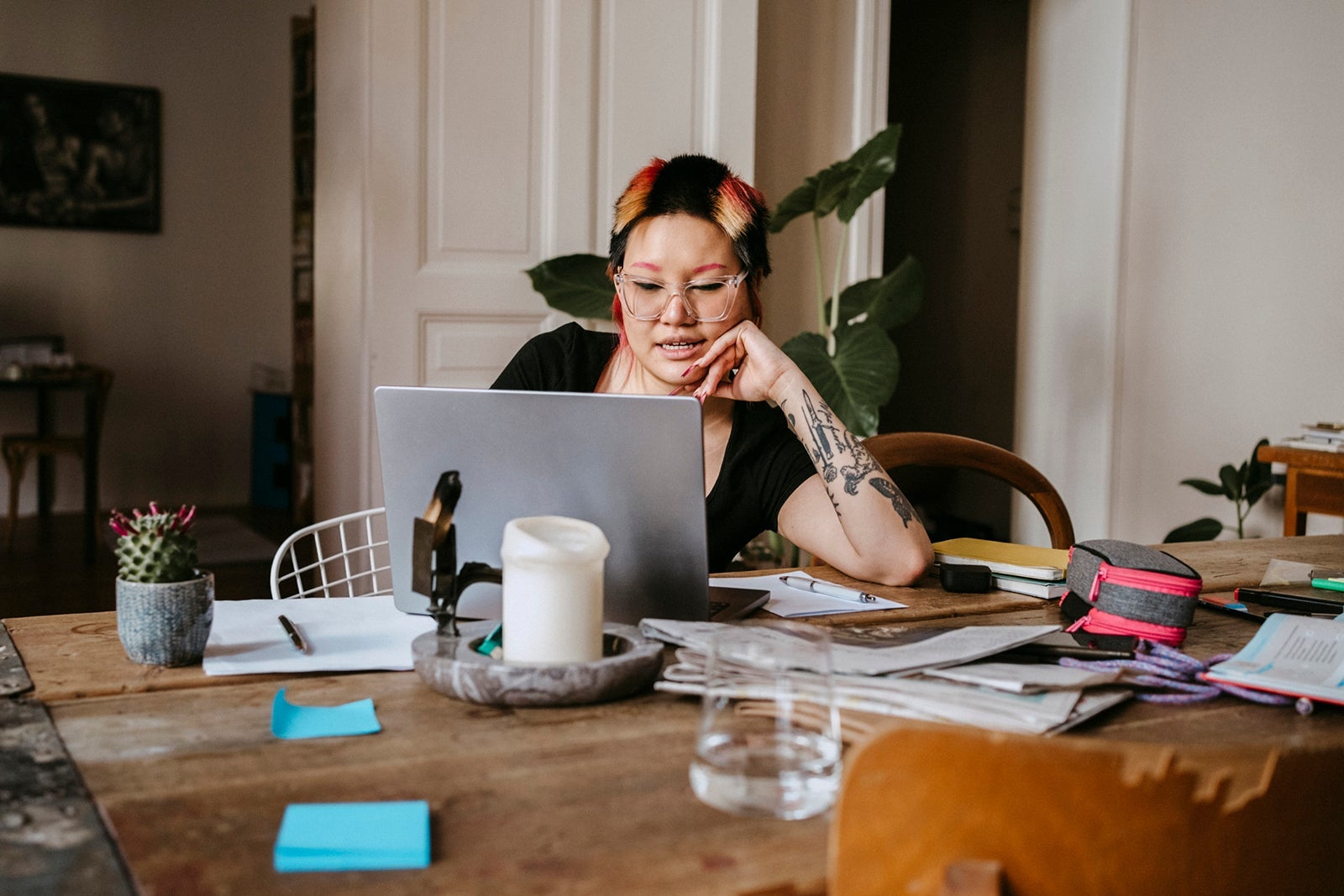 freelancer working on laptop while sitting at desk in home