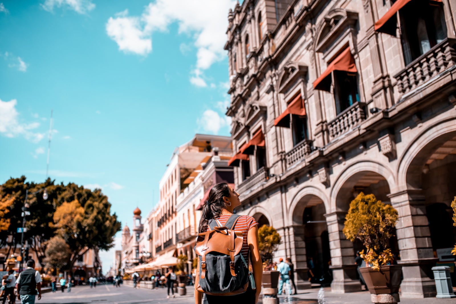A happy tourist walking down the street