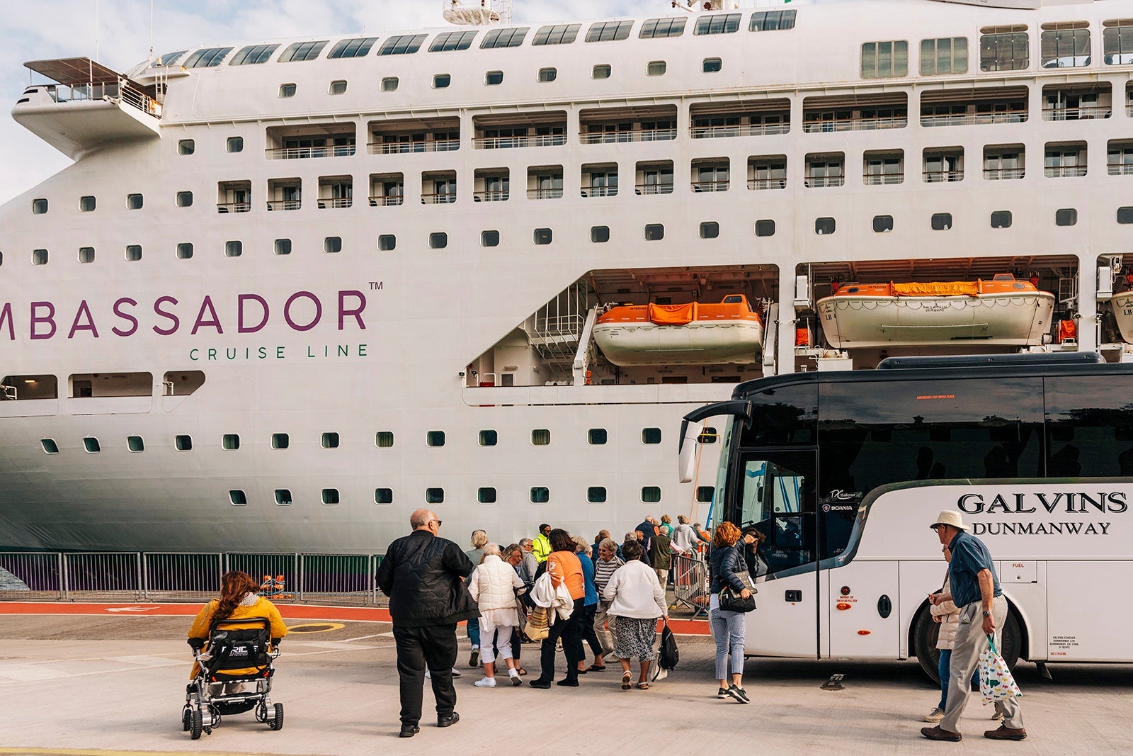 Cobh, Ireland, EU, Cruise passengers exiting a excursion coach and return to their cruise ship alongside in Cobh Harbor, Ireland.