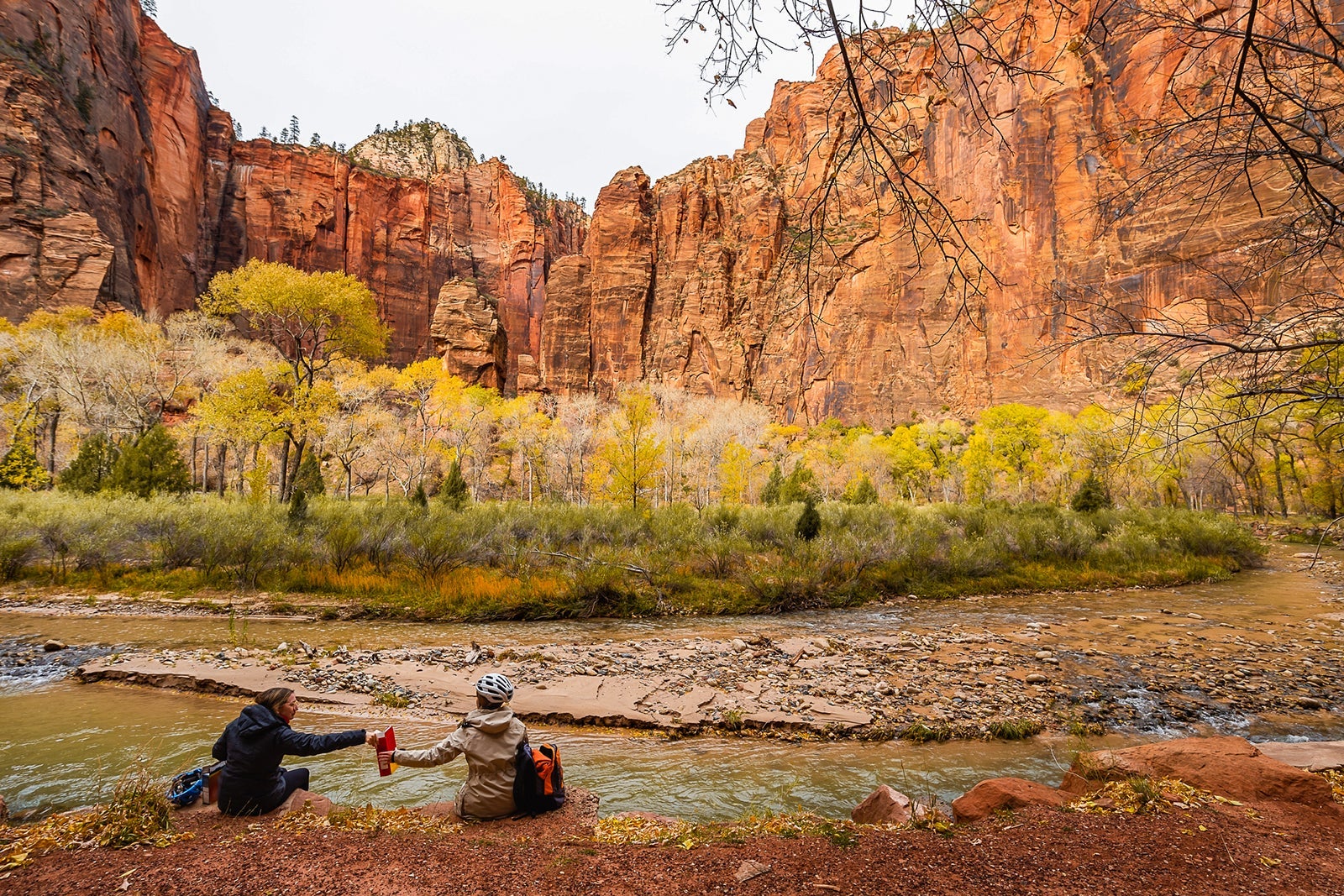Two friends are resting by the river in Zion National Park, Utah