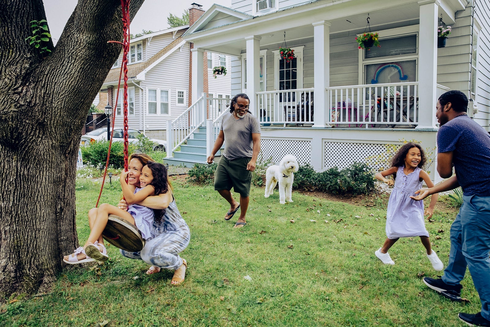 Happy family playing in front year at home