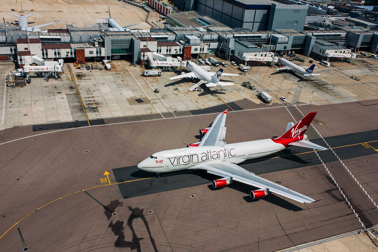UK - Hounslow - Aerial of taxiing airliner and tower shadow