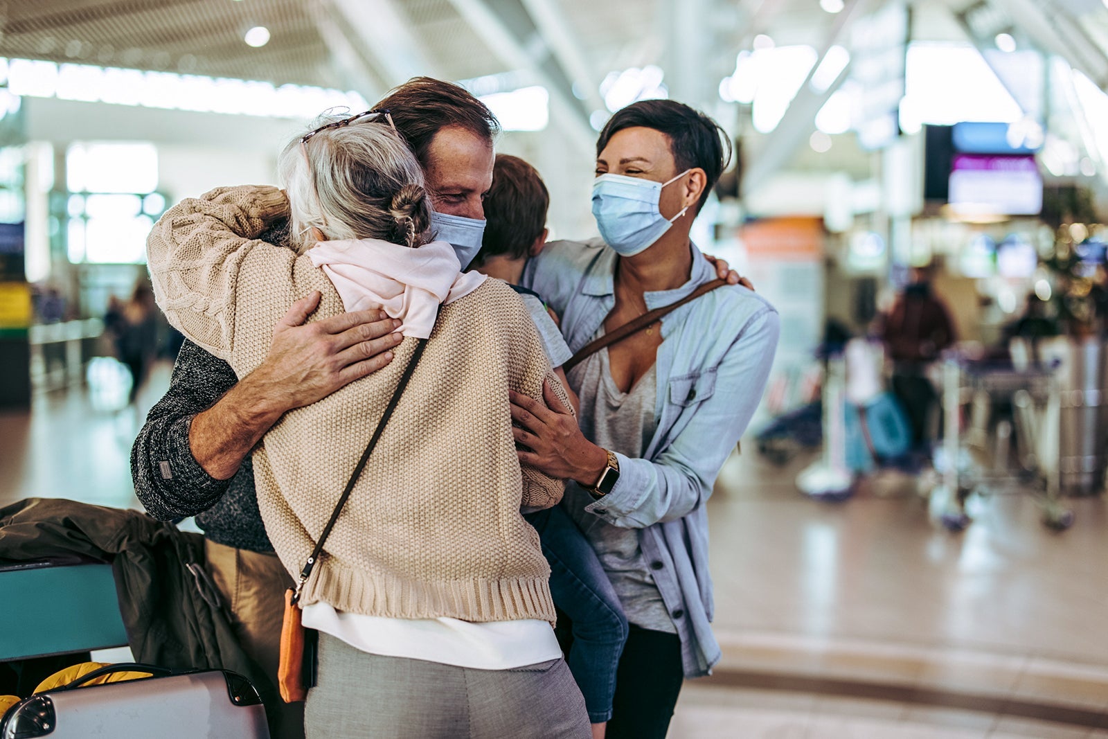 Grandmother meeting arriving family at airport