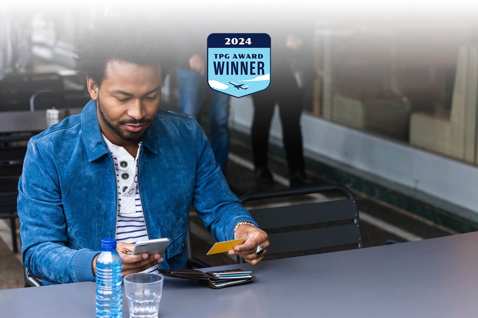 Man-using-credit-card-and-smart-phone-paying-at-cafe_Westend61