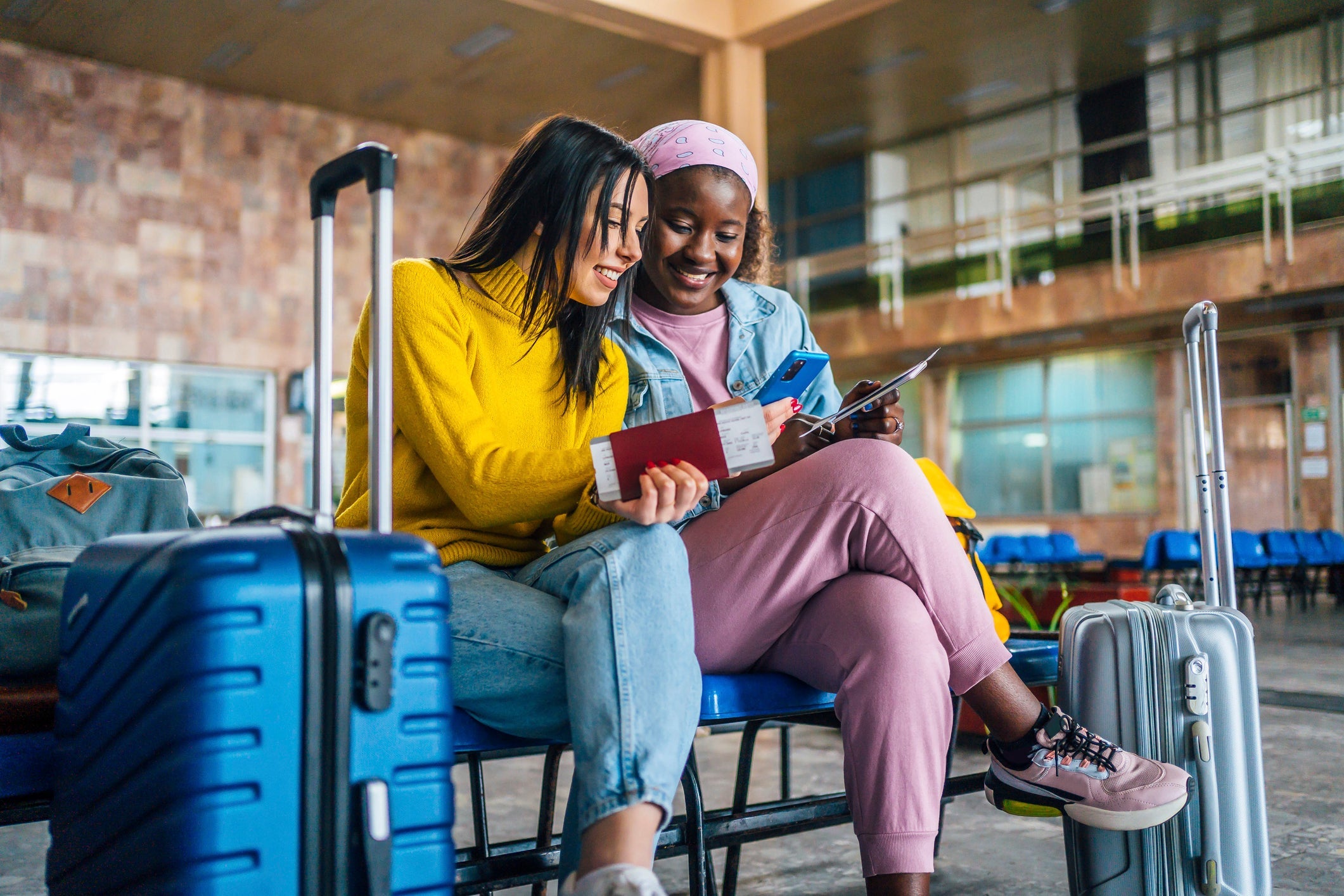 Girlfriends using mobile phone at the airport