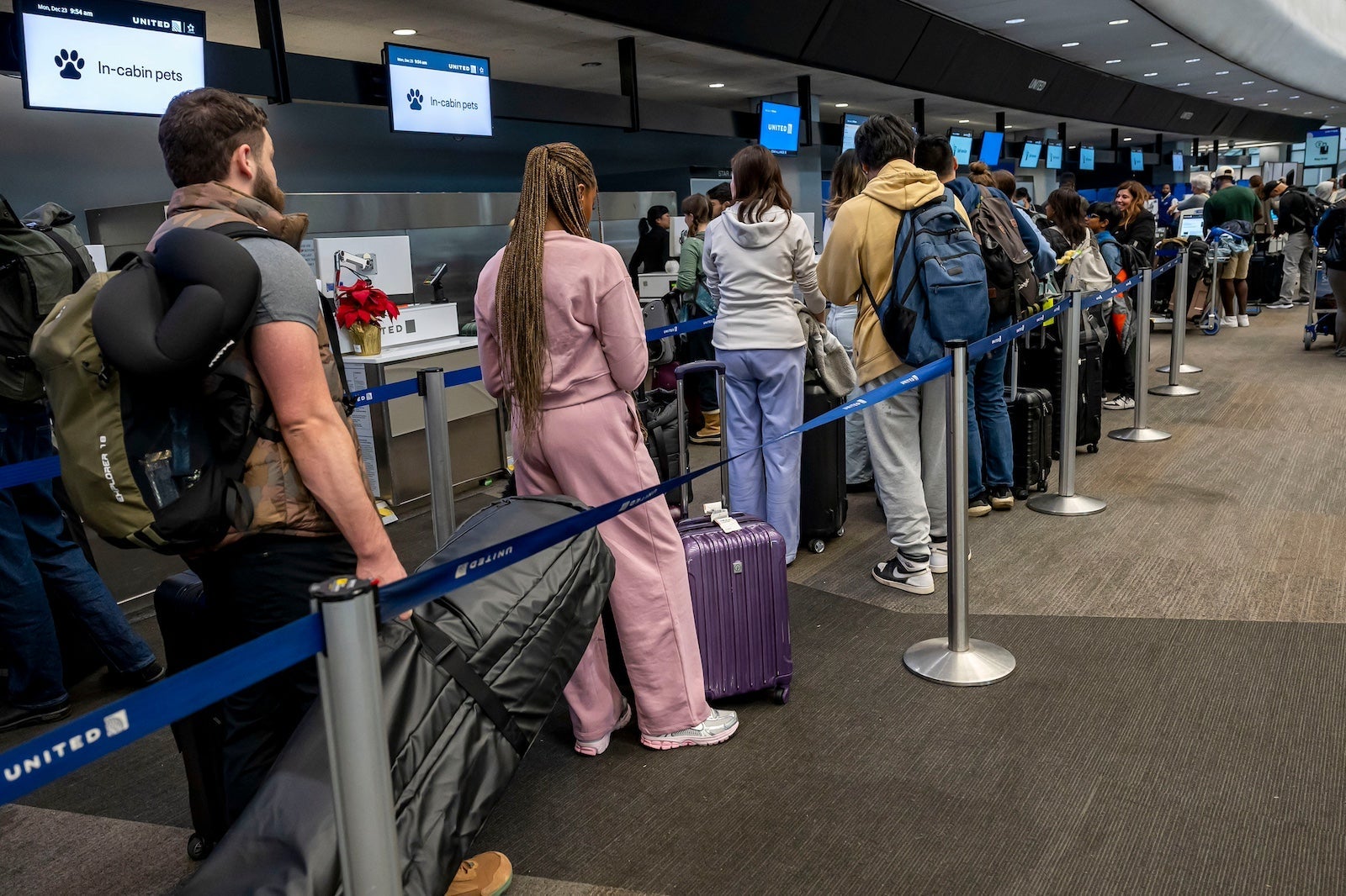 Travelers At SFO Airport Ahead Of Christmas Holiday