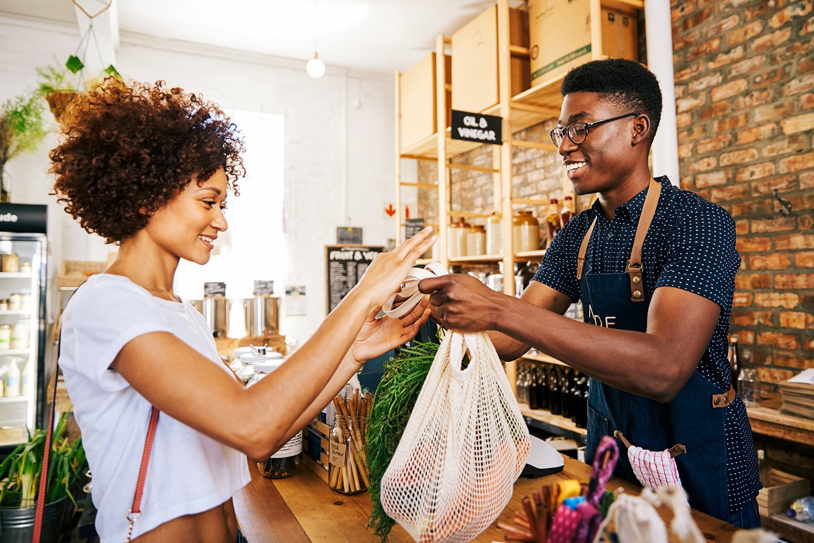 Customer,Paying,For,Shopping,At,Checkout,Of,Sustainable,Plastic,Free