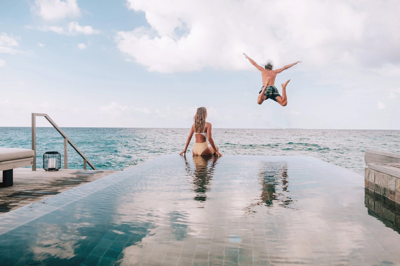 Couple enjoying infinity pool at hotel_MYSTOCKIMAGES