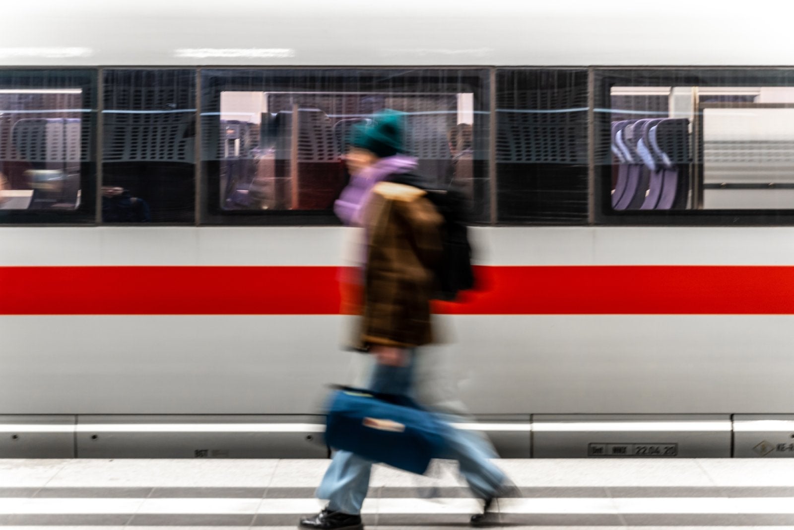 Blurred Motion Of Woman Against Train At Railroad Station