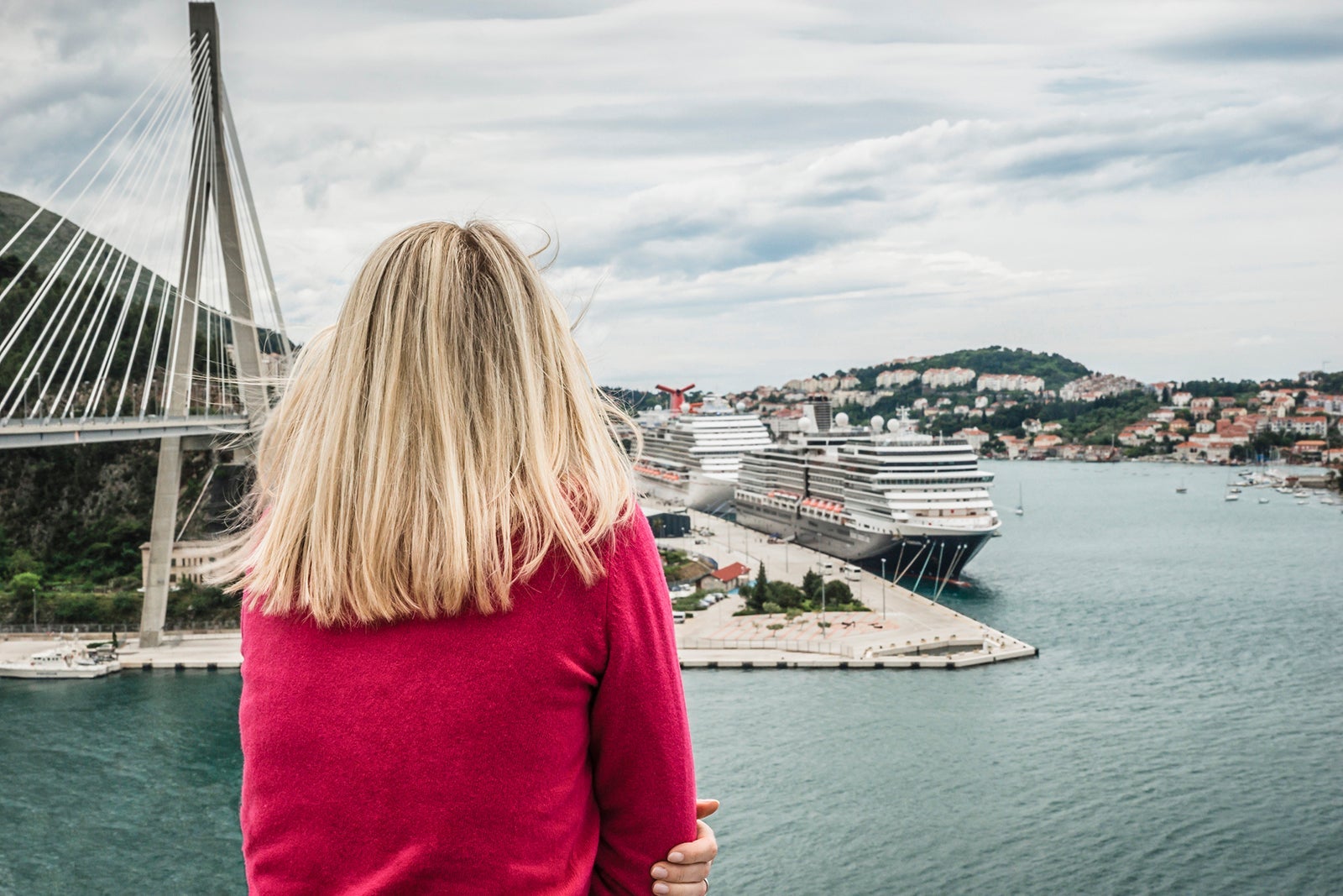 Croatia, Dubrovnik, back view of woman looking to the harbour