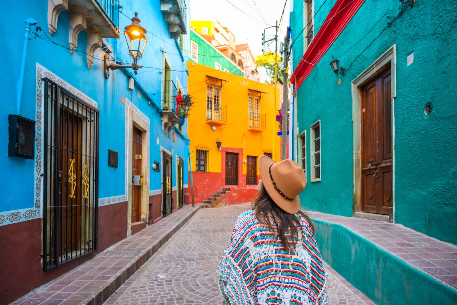 Tourist exploring colorful backstreets in Guanajuato, Mexico