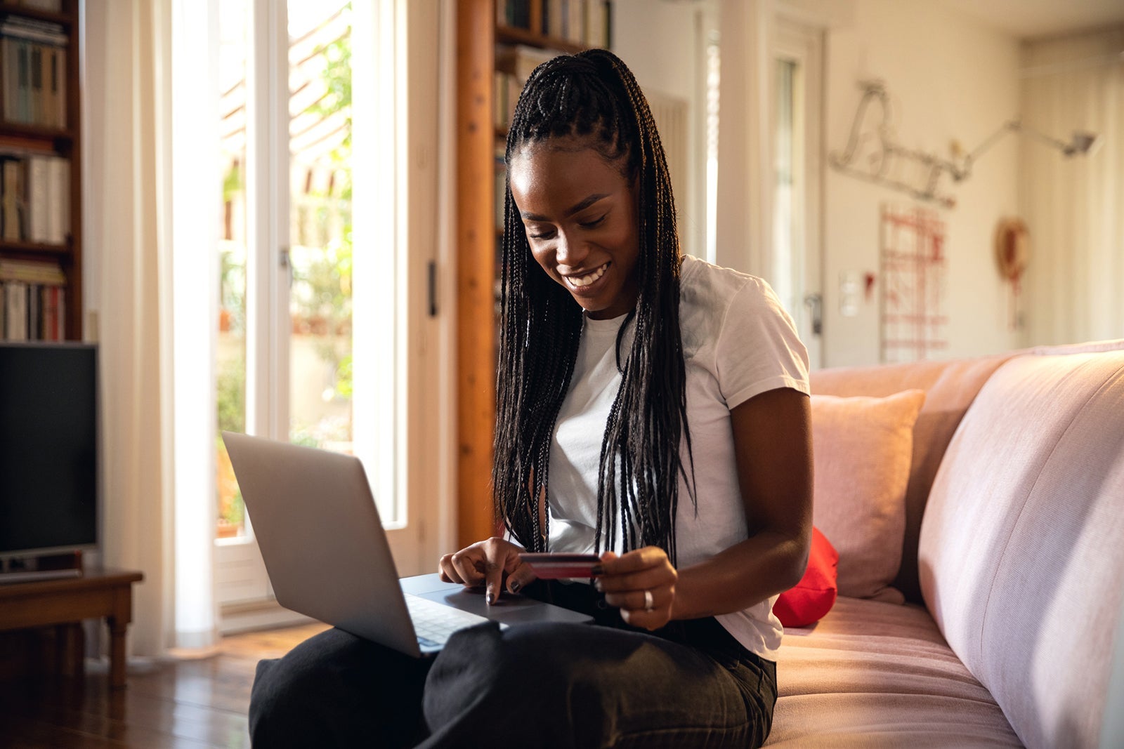 Woman shopping online and relaxing on the sofa at home